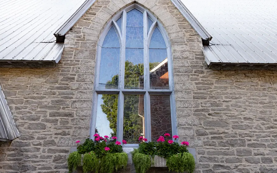 View of a window from the outside with some flowers