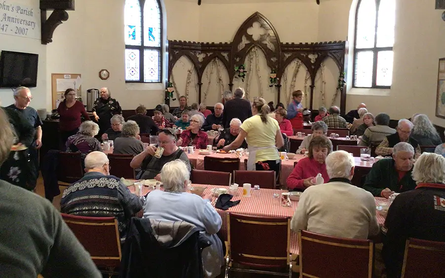 People eating at the community dinner at St. John's
