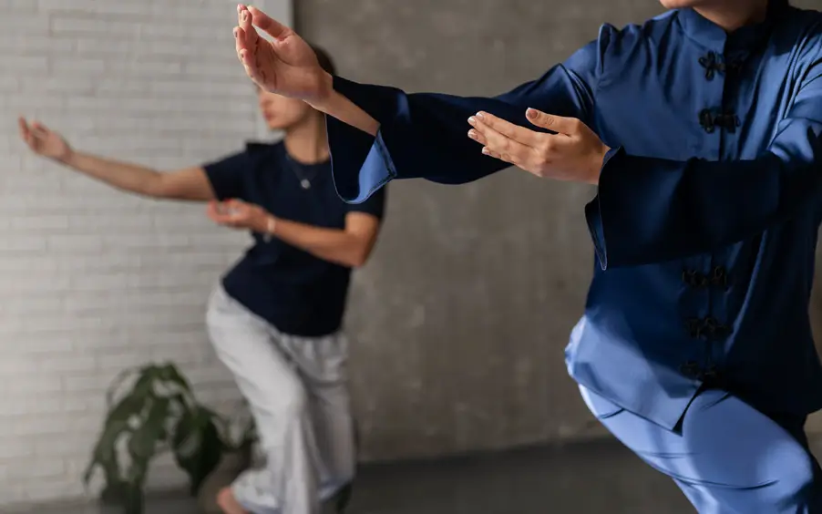 Two women doing Tai Chi with their hands